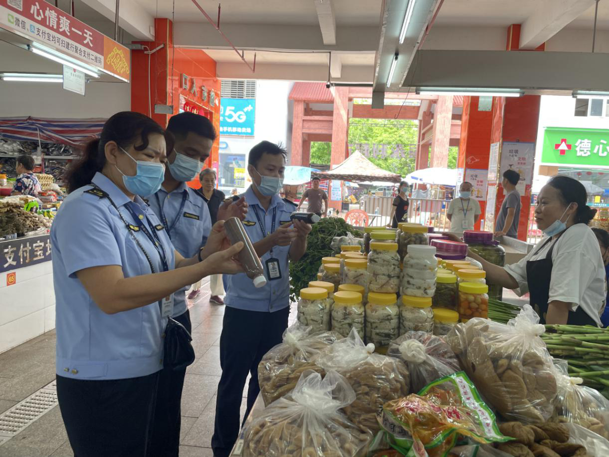 执法人员检查农贸市场摊贩食品盛装容器 (3).png